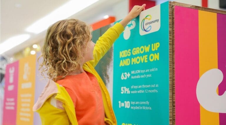 Girl putting toy in a bin